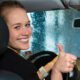 7136765-young-woman-drives-car-in-wash-station